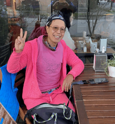 Roland's funny pink outfit a pink onesie from onepiece.com from Norway at Commercial Street Cafe, East Vancouver, Canada