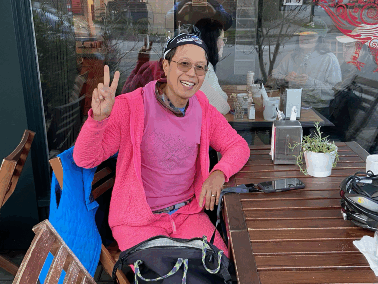 Roland's funny pink outfit a pink onesie from onepiece.com from Norway at Commercial Street Cafe, East Vancouver, Canada