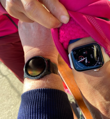 Garmin Watch next to an Apple Watch at Commercial Street Cafe, Vancouver, Canada